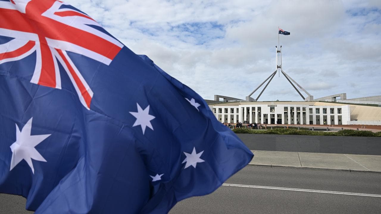 An Australian flag flying in front of Parliament House in Canberra.