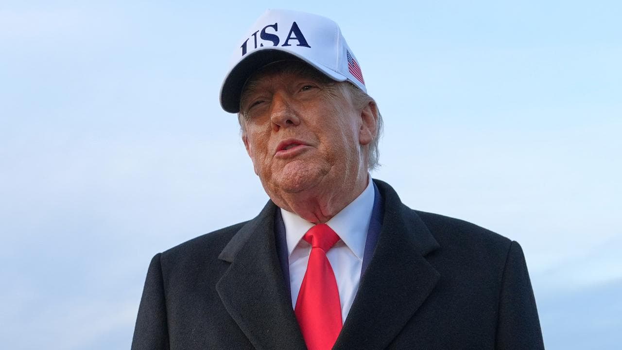 US President Donald Trump speaks with reporters at Joint Base Andrews