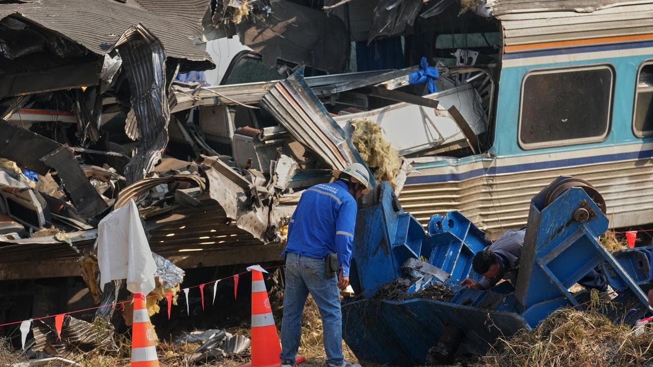 Wreckage at the site where a crane fell onto a train in Thailand