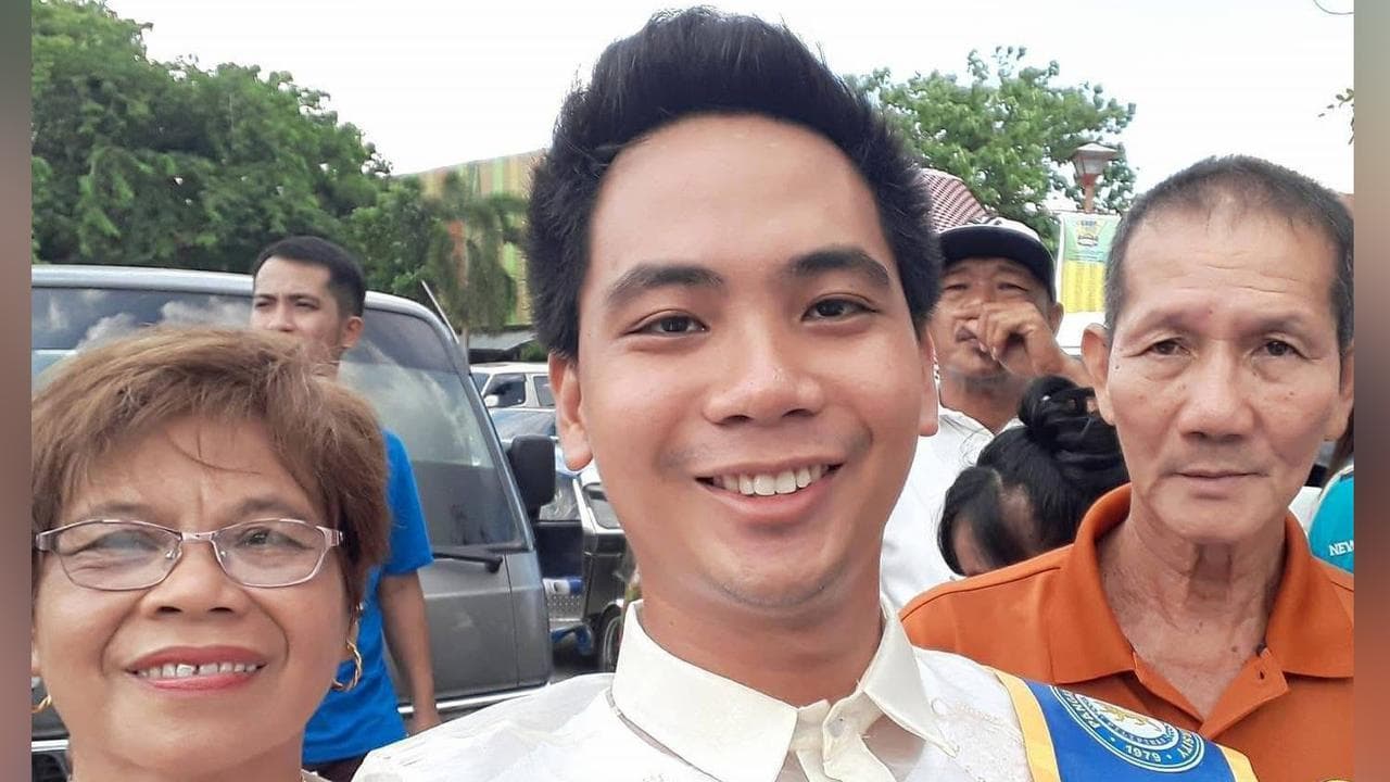 Jerwin Royupa poses with his parents on his graduation day