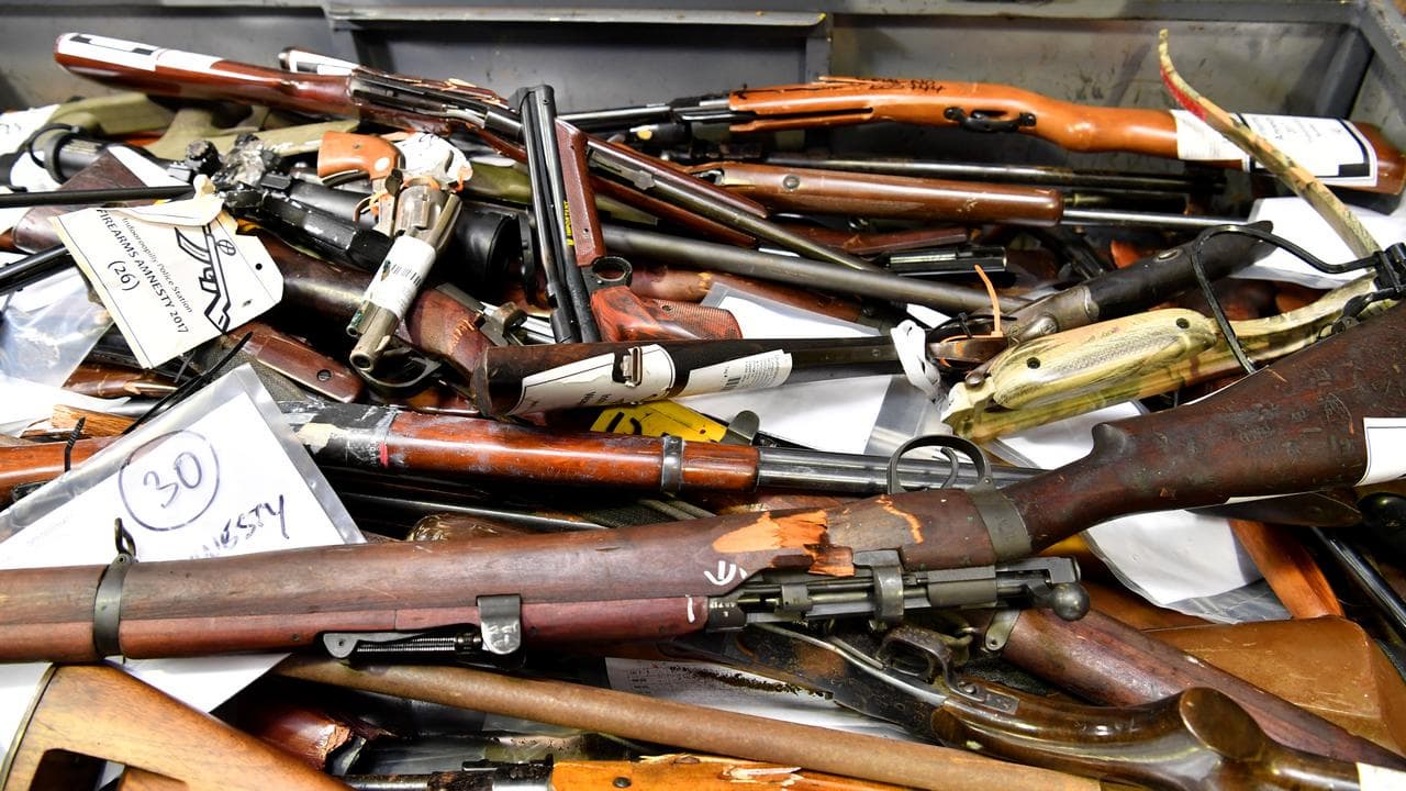 Confiscated firearms are put on display for the media in Brisbane