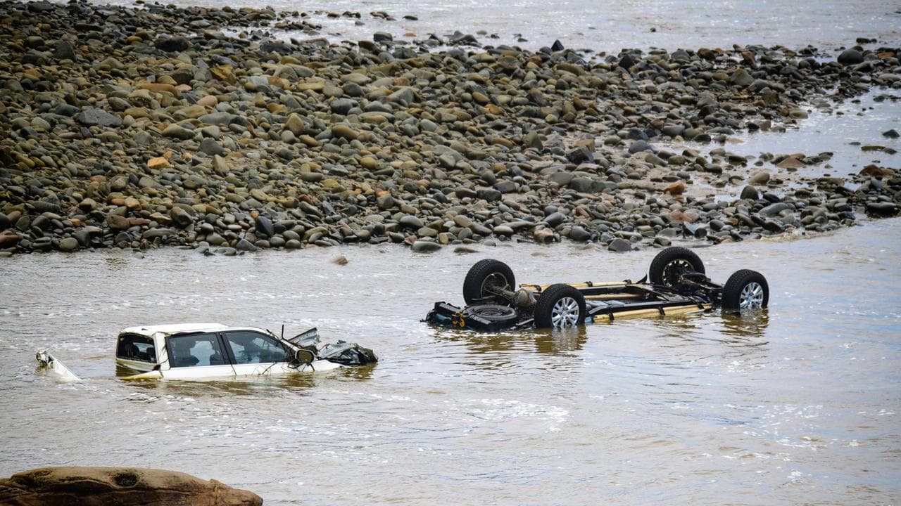 cars washed into the surf by a flood