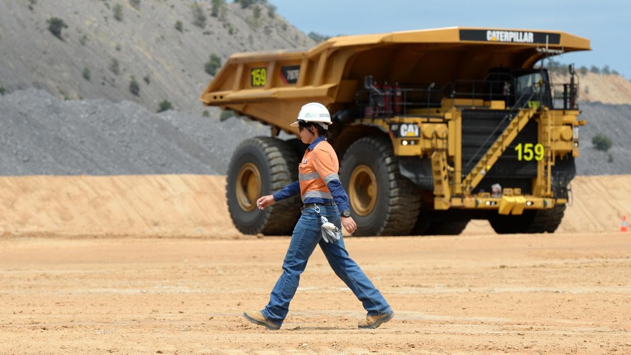 A worker and truck at a BHP mine (file image_