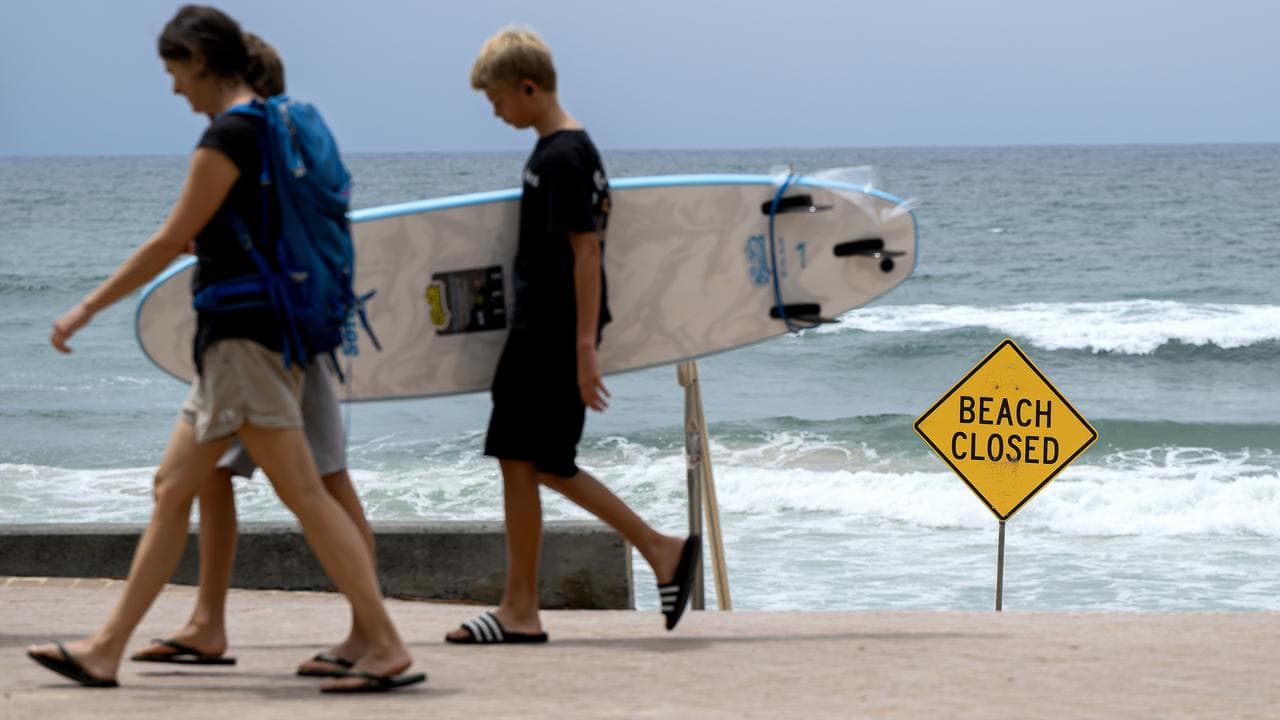 People walk beside North Steyne Beach in Sydney