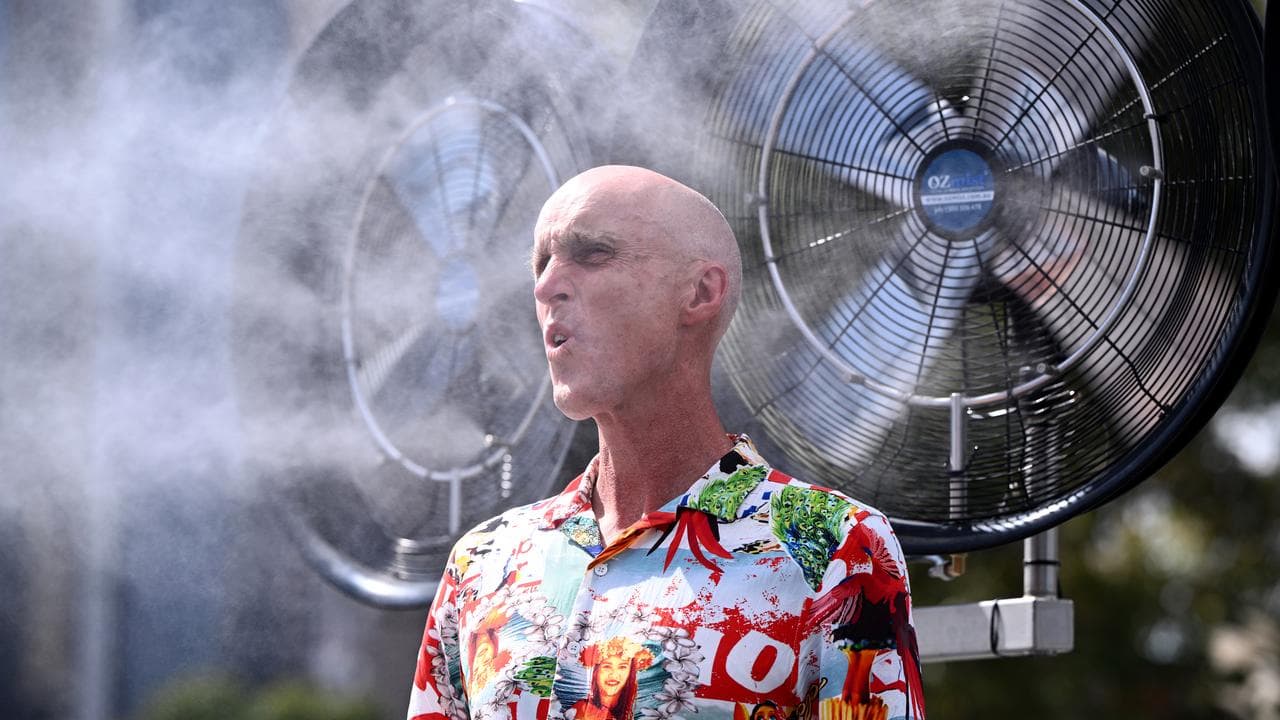 A spectator under a fan.