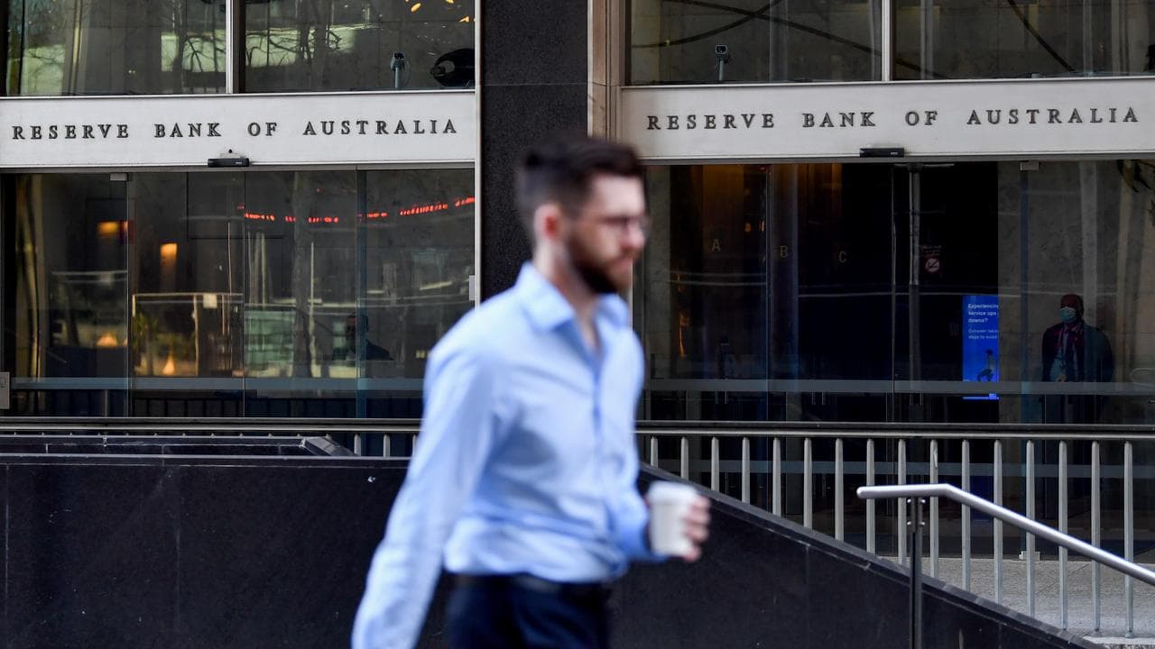 pedestrian walks past the Reserve Bank of Australia