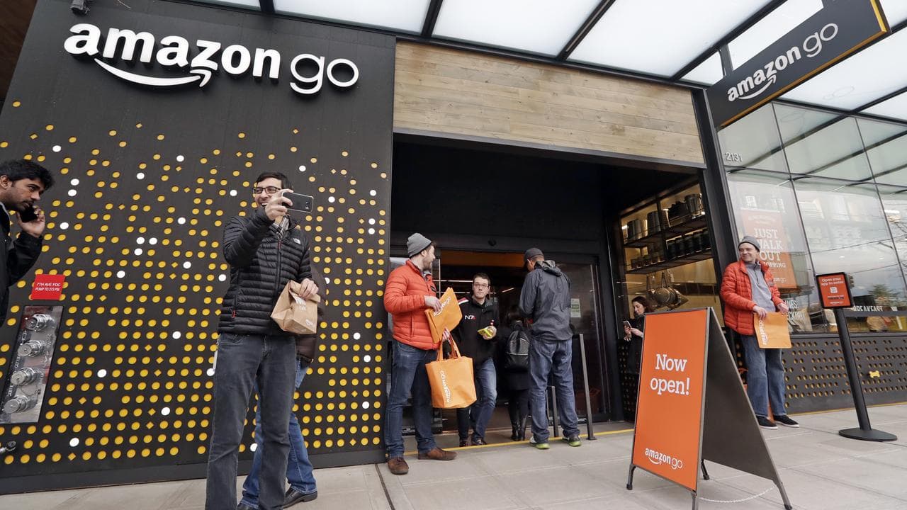 People stand outside an Amazon Go store in Seattle