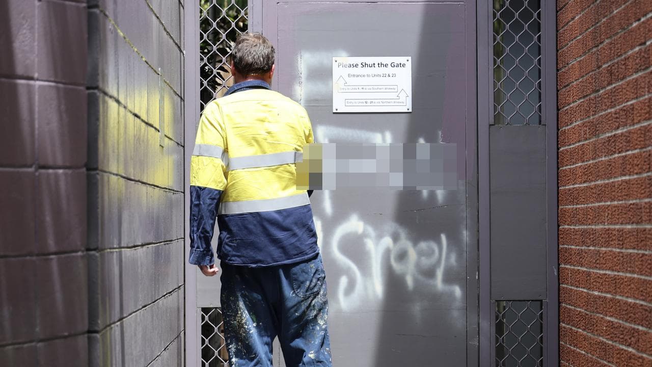 Worker cleans graffiti (file)