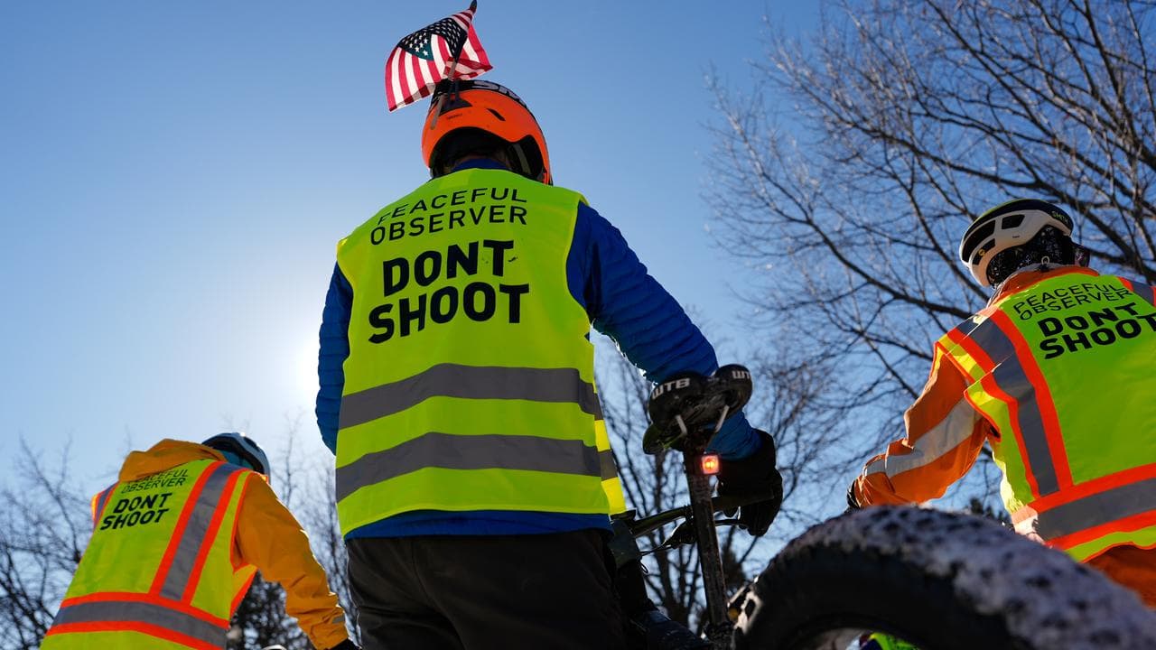 People on a solidarity bike ride for Alex Pretti and Renee Good