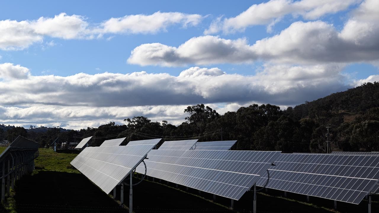 A row of solar panels in a field