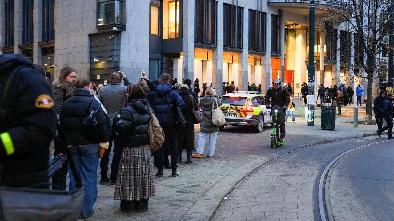 A crowd queues outside Oslo Courthouse
