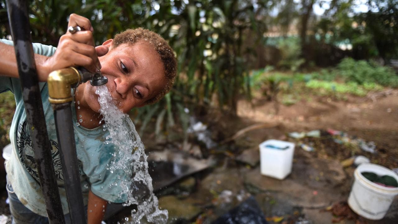 A child drinks water from a tap (file image)
