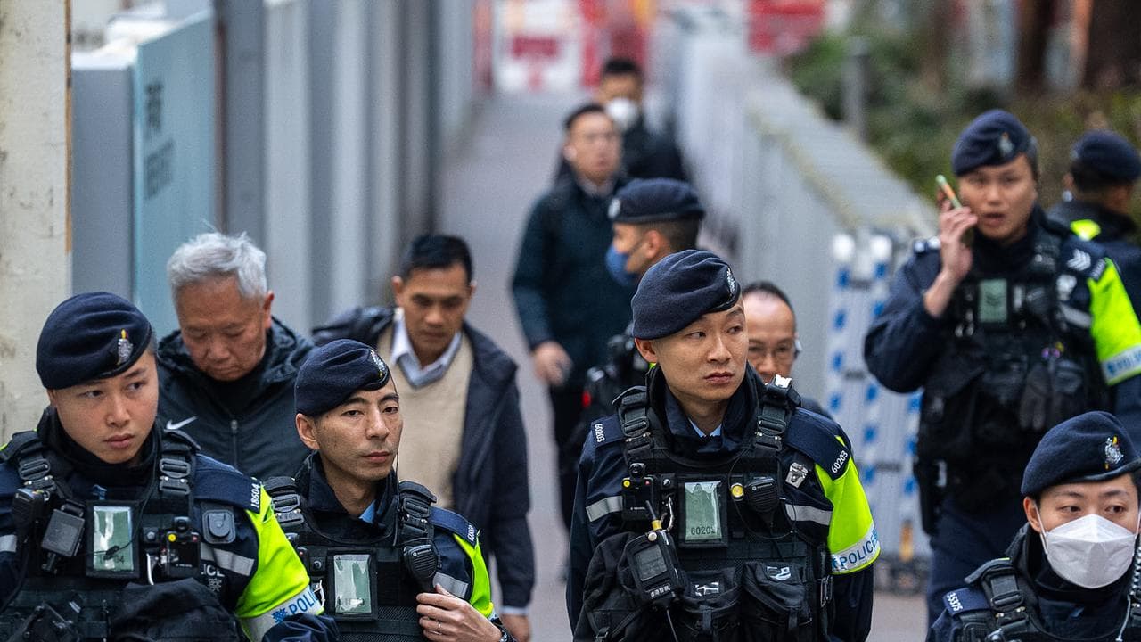 Police officers guard outside the West Kowloon Magistrates' Courts
