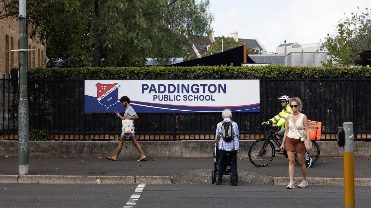A photo of people outside a school.