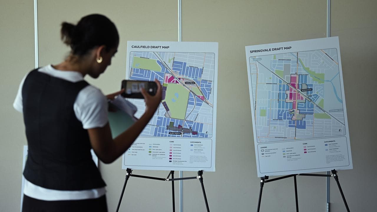 A person taking a photo of the draft maps