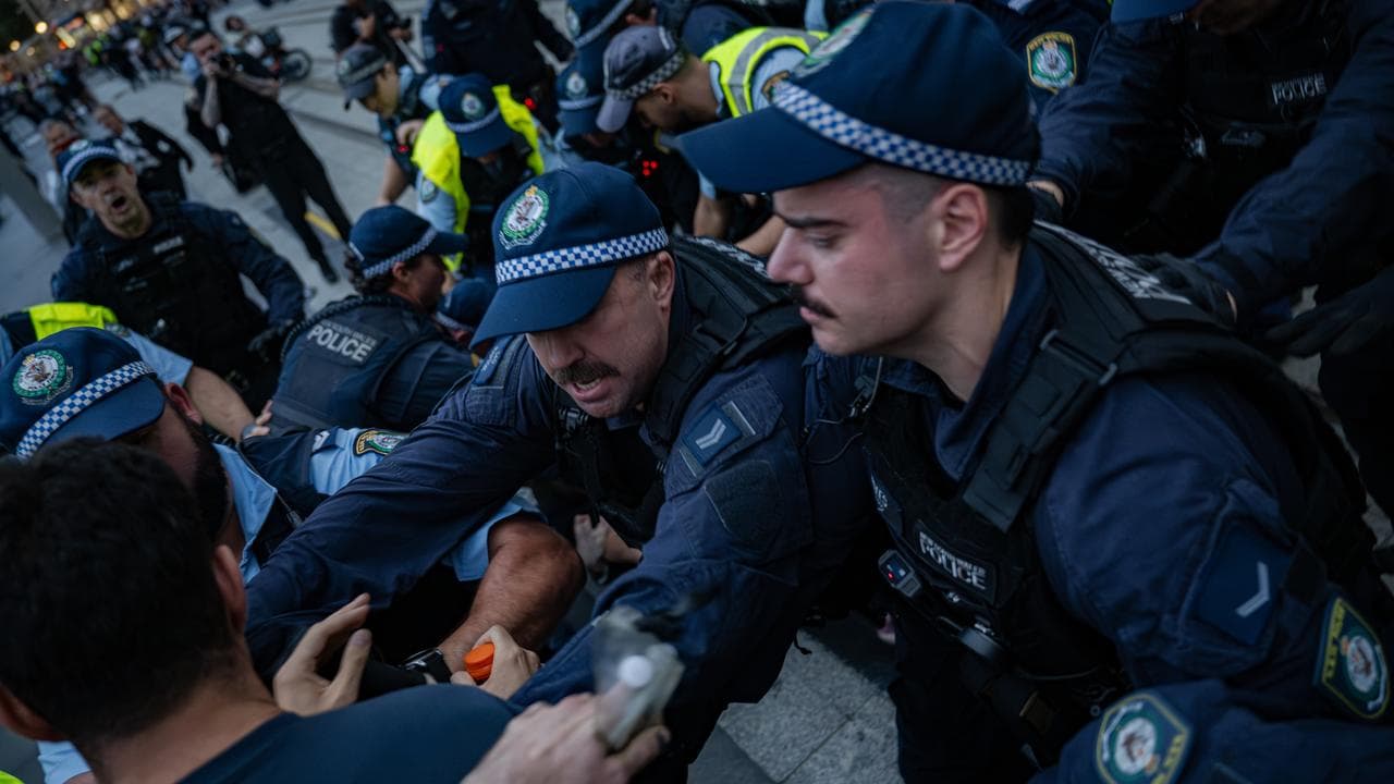 Police officers face-off with demonstrators near Sydney's Town Hall