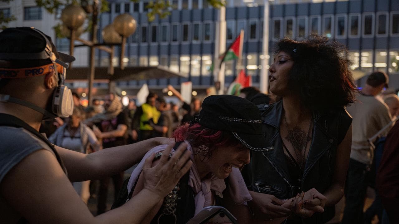 Protesters react after being exposed to pepper spray