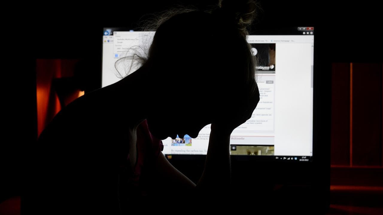 Upset girl in front of a personal computer in Brisbane