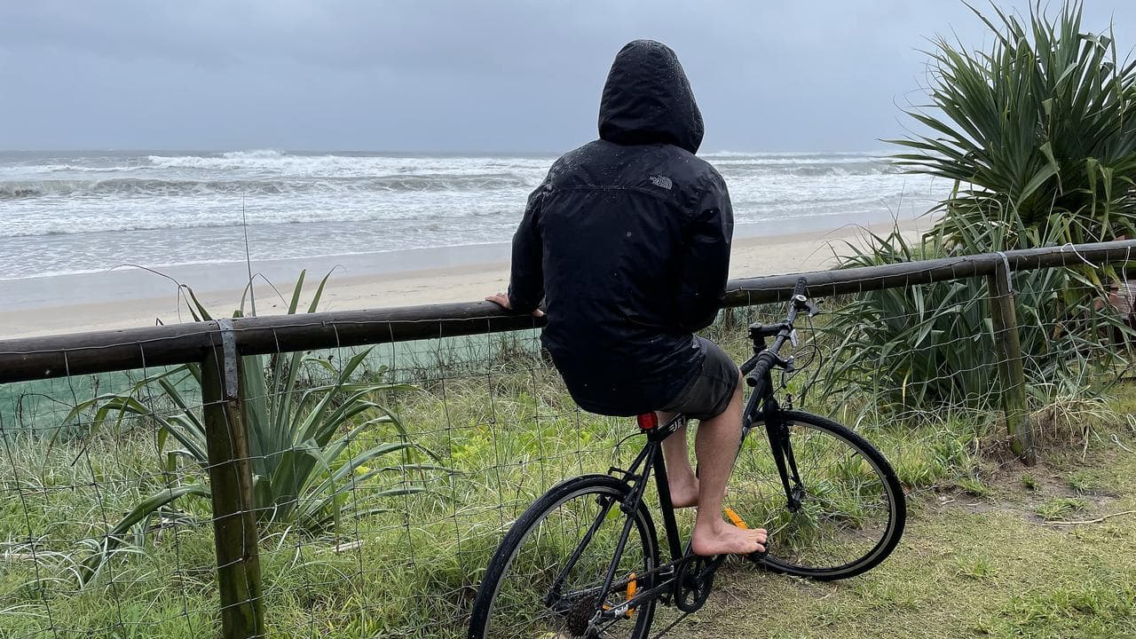 Man on pushbike at beach