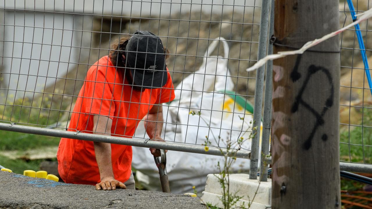 A construction worker digs a hole in Melbourne