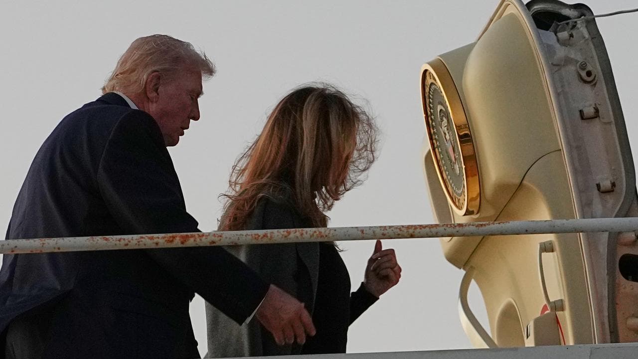 Donald Trump and first lady Melania Trump board Air Force One