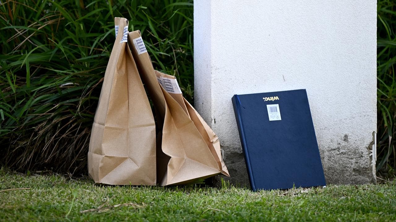 Police evidence bags at a house after a shooting in Greenacre, Sydney
