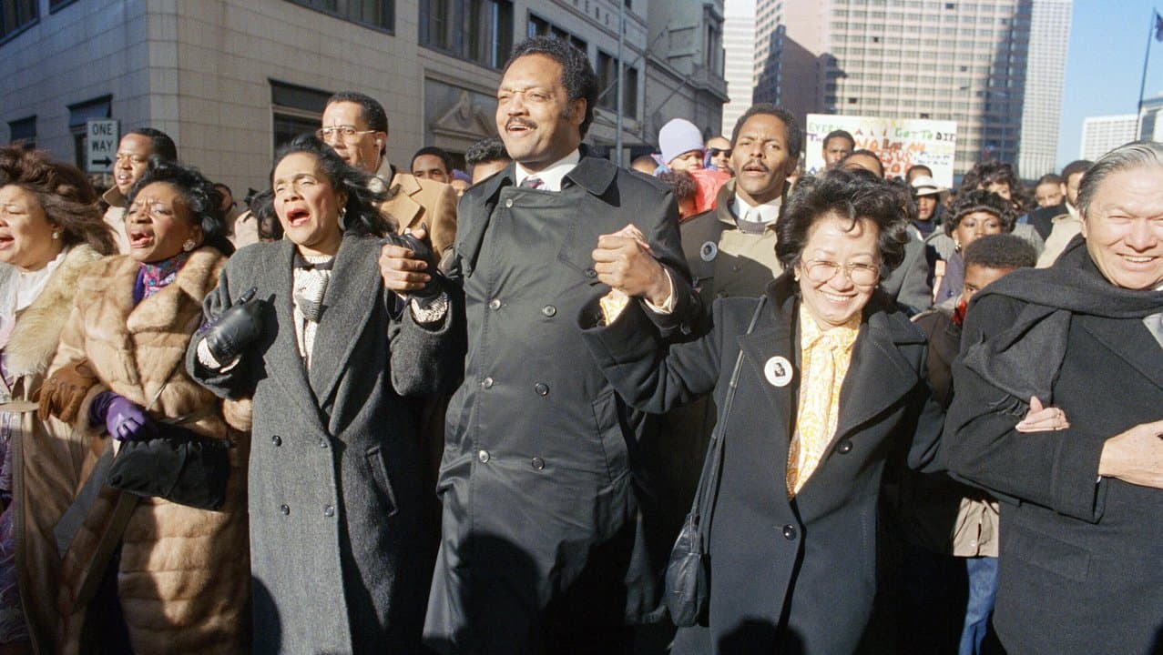 Coretta Scott King holds with Jesse Jackson in Atlanta in 1987