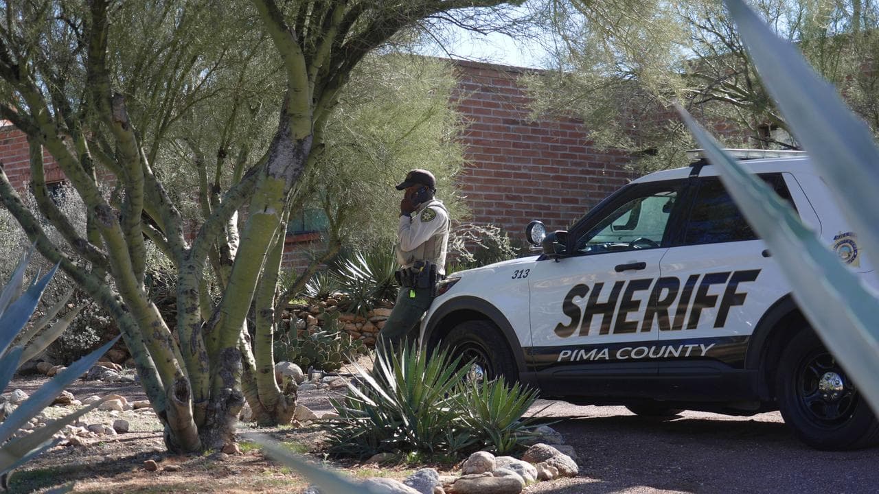 A Pima County sheriffs official stays outside of Nancy Guthrie‘s home