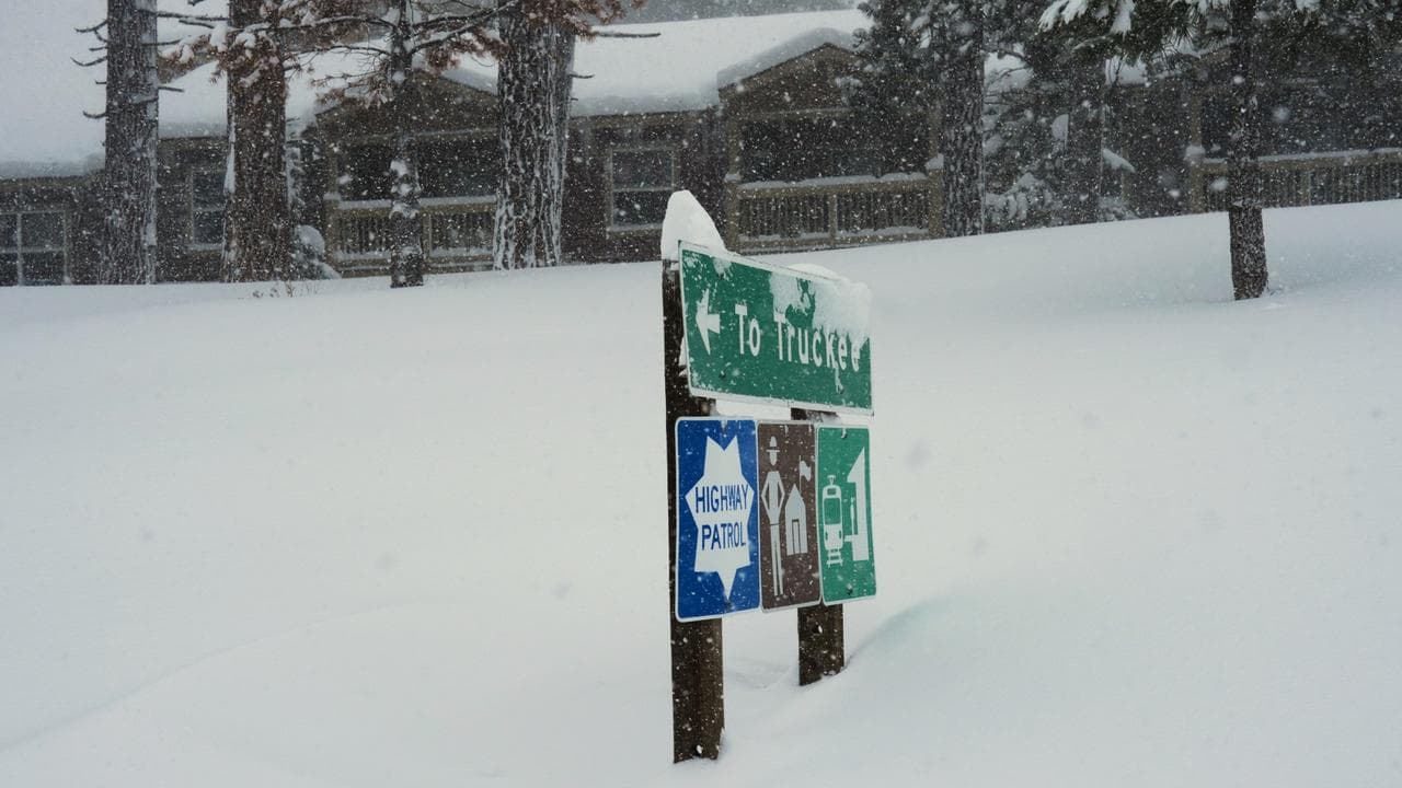 A sign is covered in snow during a storm in Truckee, California