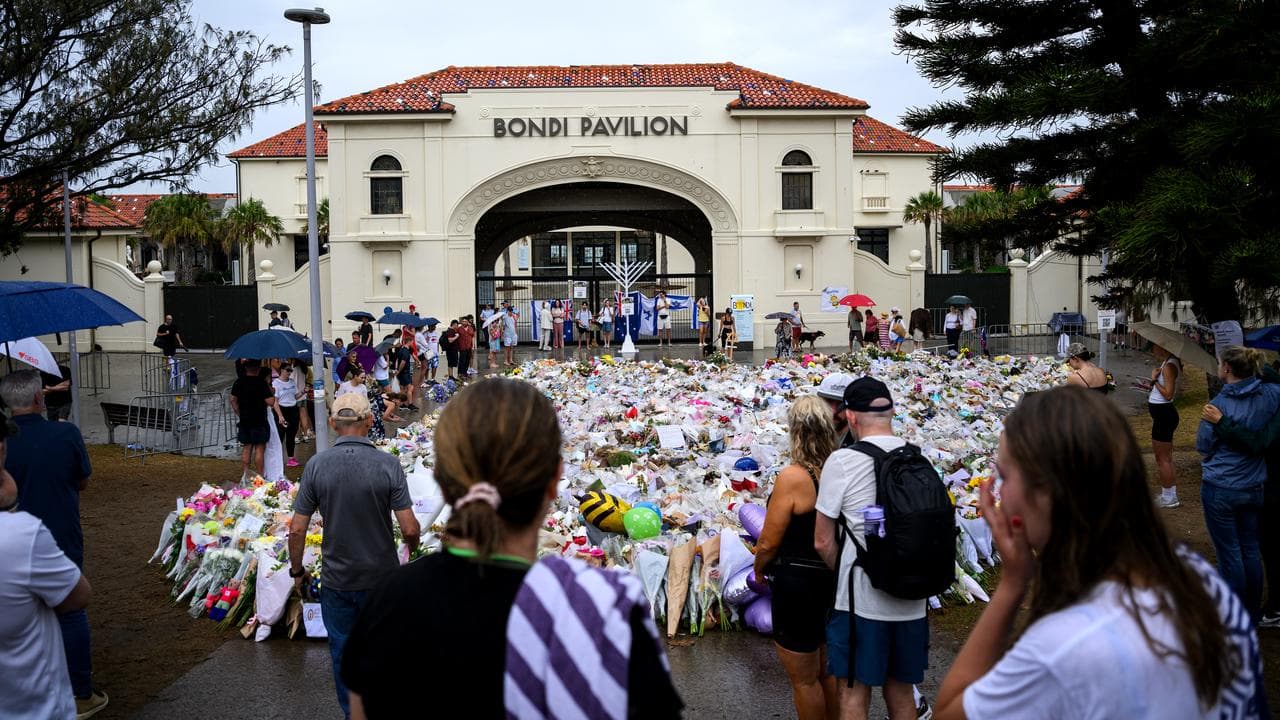 Mourners place flowers at a memorial at Bondi Beach