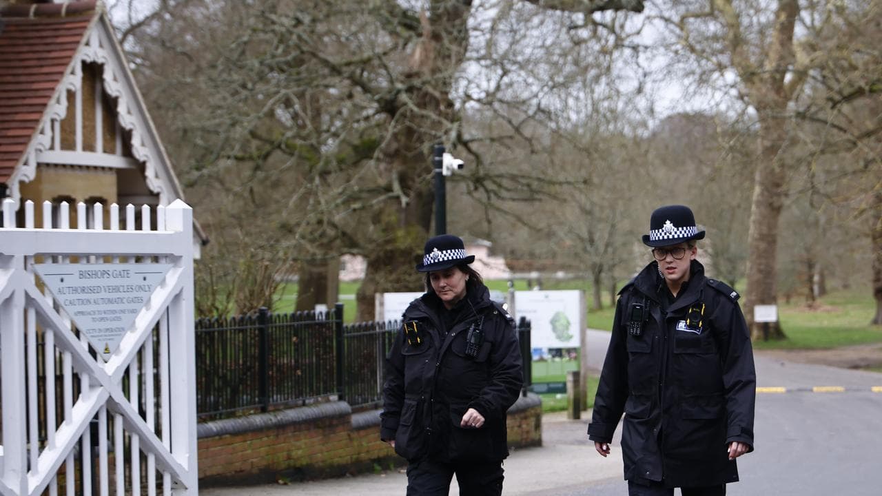 Police officers patrol the area around Royal Lodge