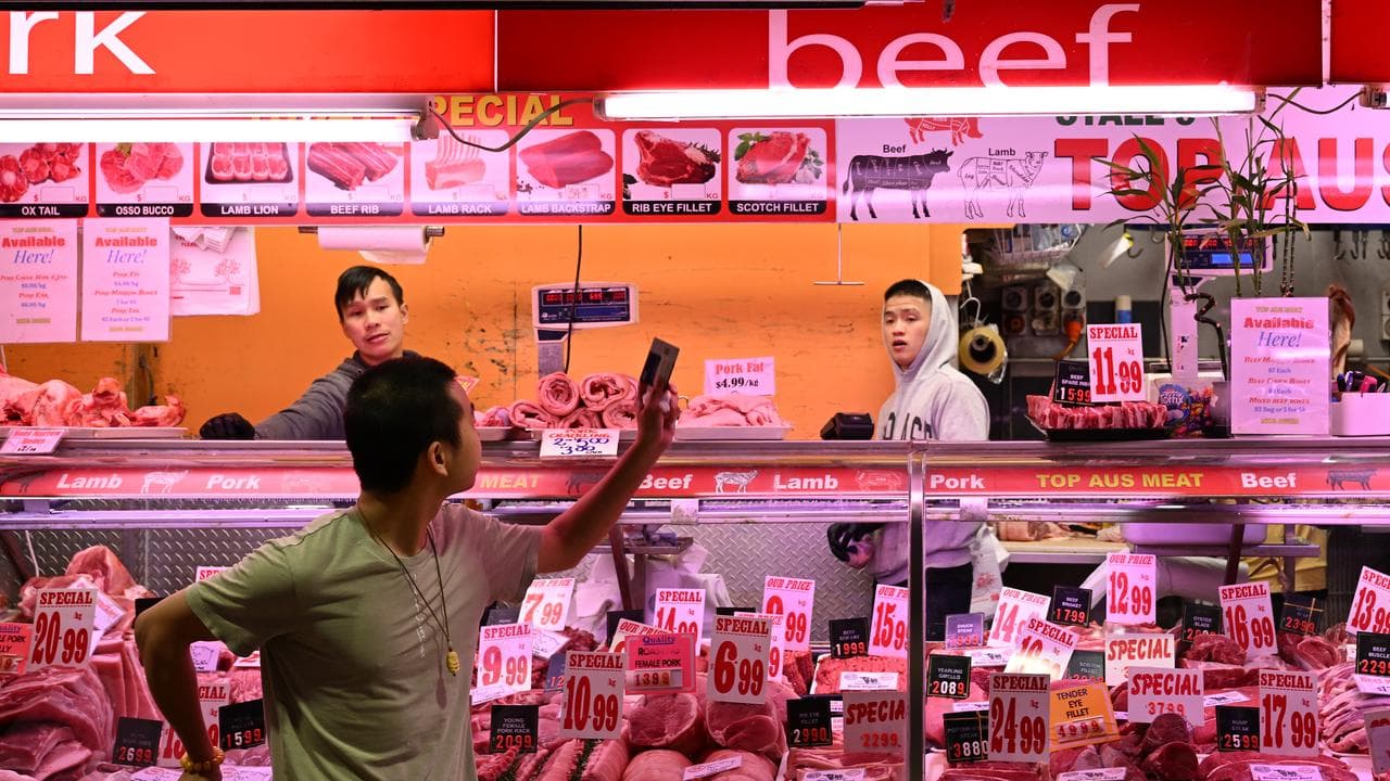 Butchers are seen at the Queen Victoria Market