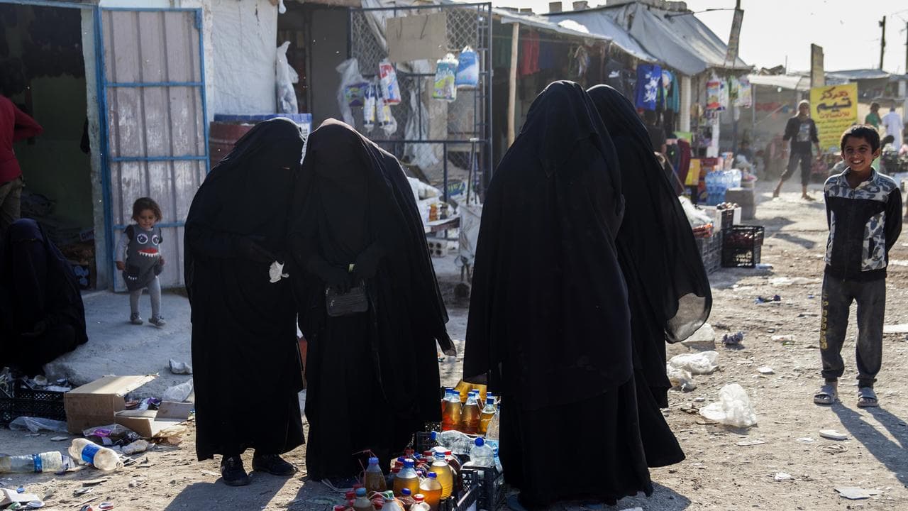 women buying food at the ‘Iraqi market’ in Al Hawl camp, Syria