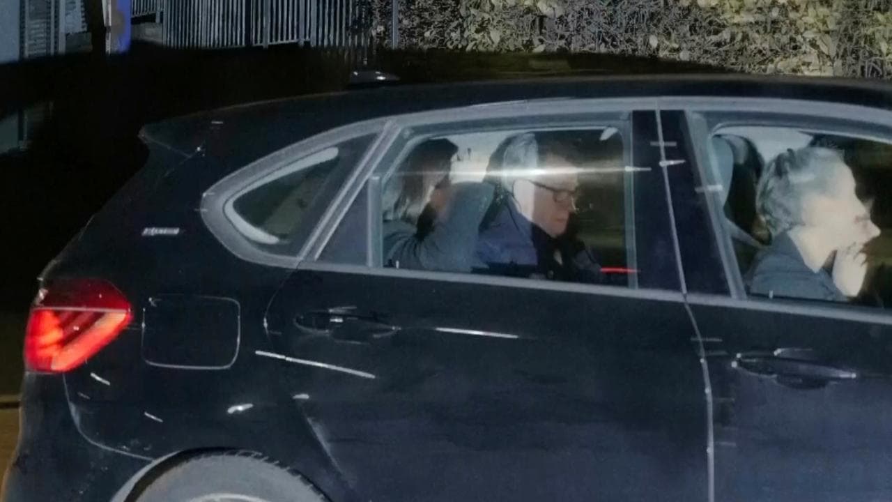 Peter Mandelson in a vehicle leaving a police station in London