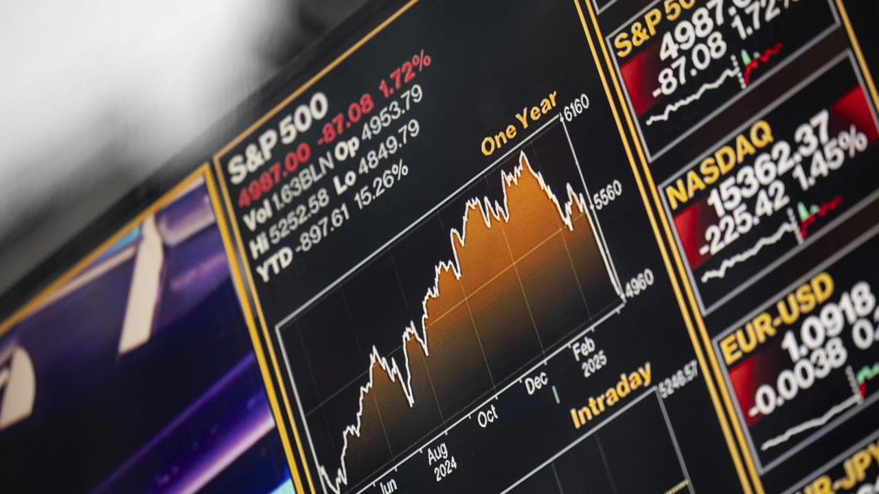 A screen shows stock prices at the Nasdaq MarketSite in New York