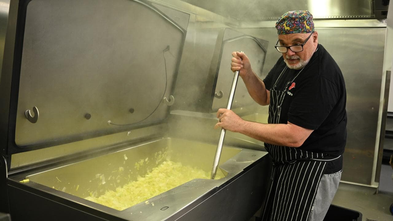 A volunteer at Fair Share / SecondBite processing facility