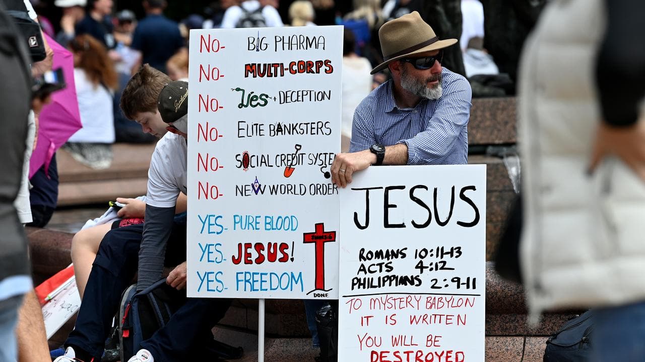 Protesters hold placards