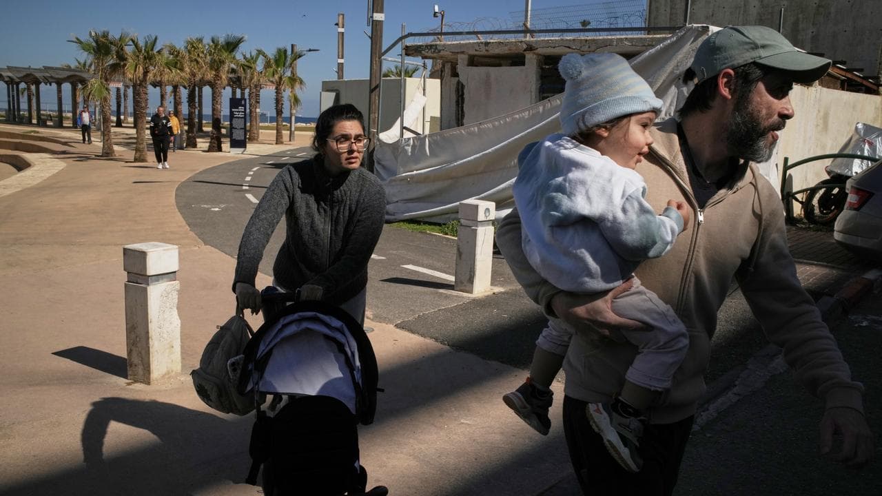 A couple with their two children rush to a shelter in northern Israel