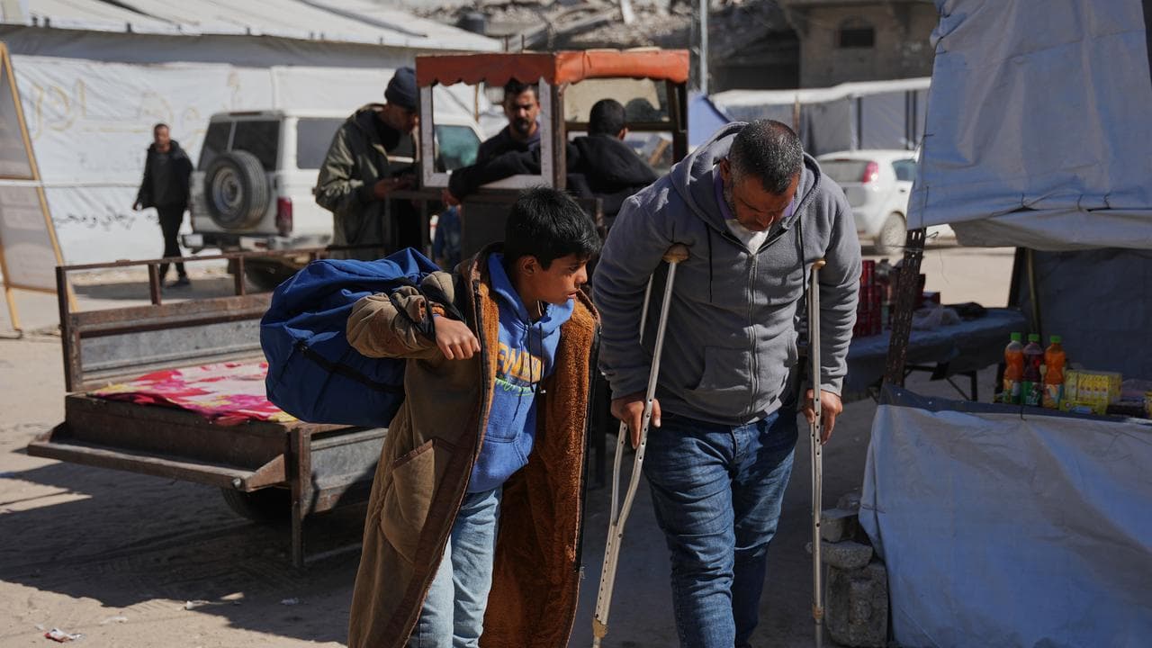 Palestinians board a bus before they head to the Rafah crossing,