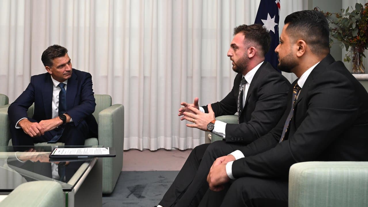 Angus Taylor listens to members of the Yazidi community
