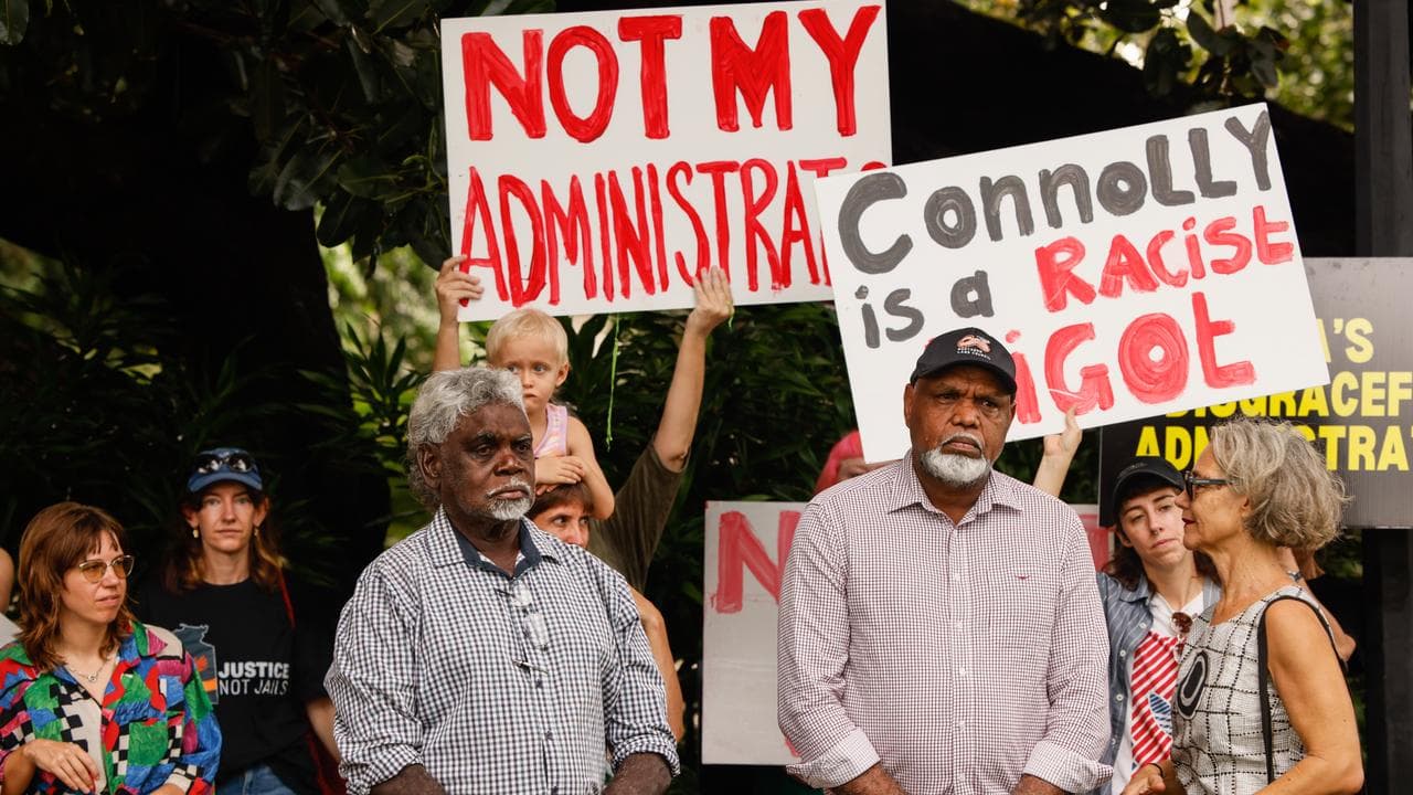 People participate in a protest as David Connolly is sworn in
