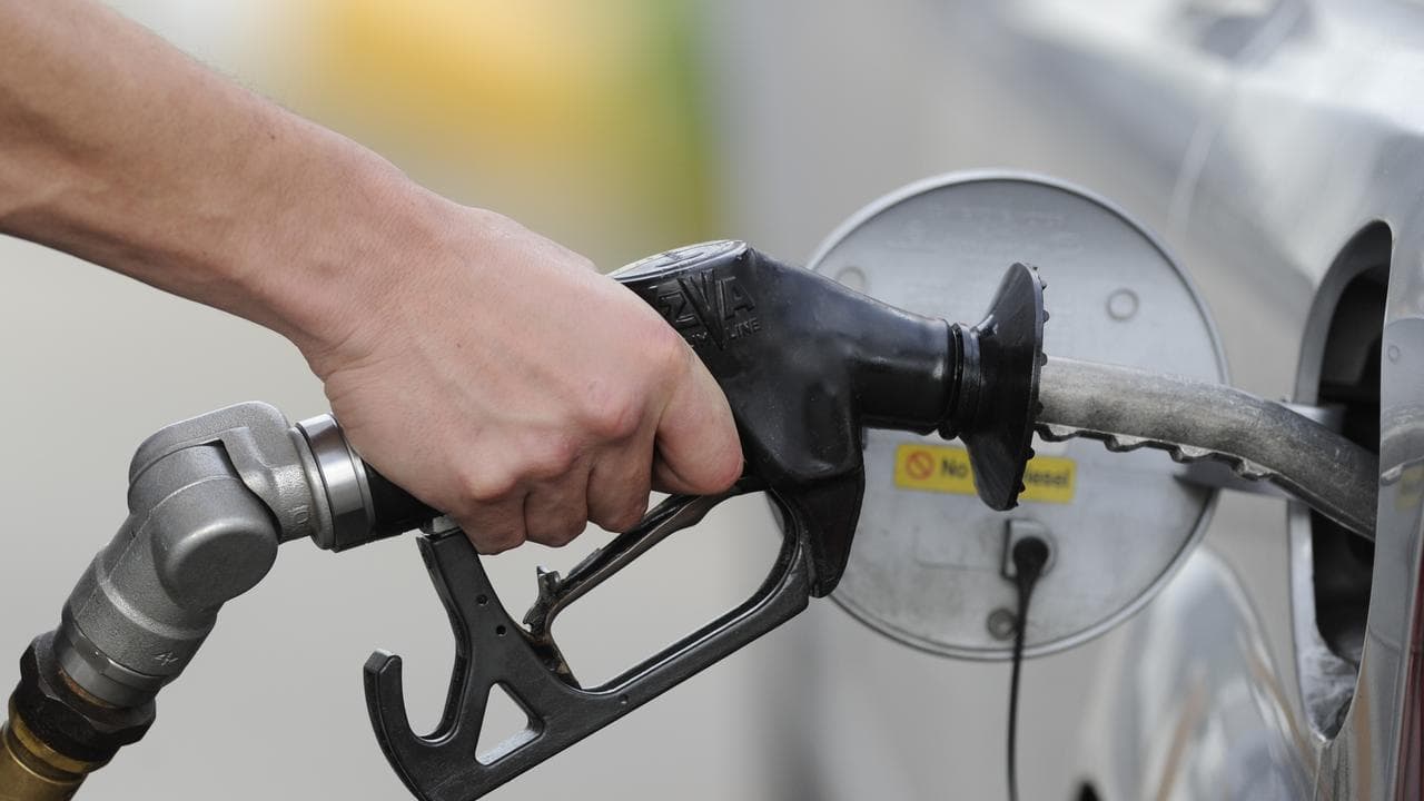 A man pumps petrol at a service station in Melbourne