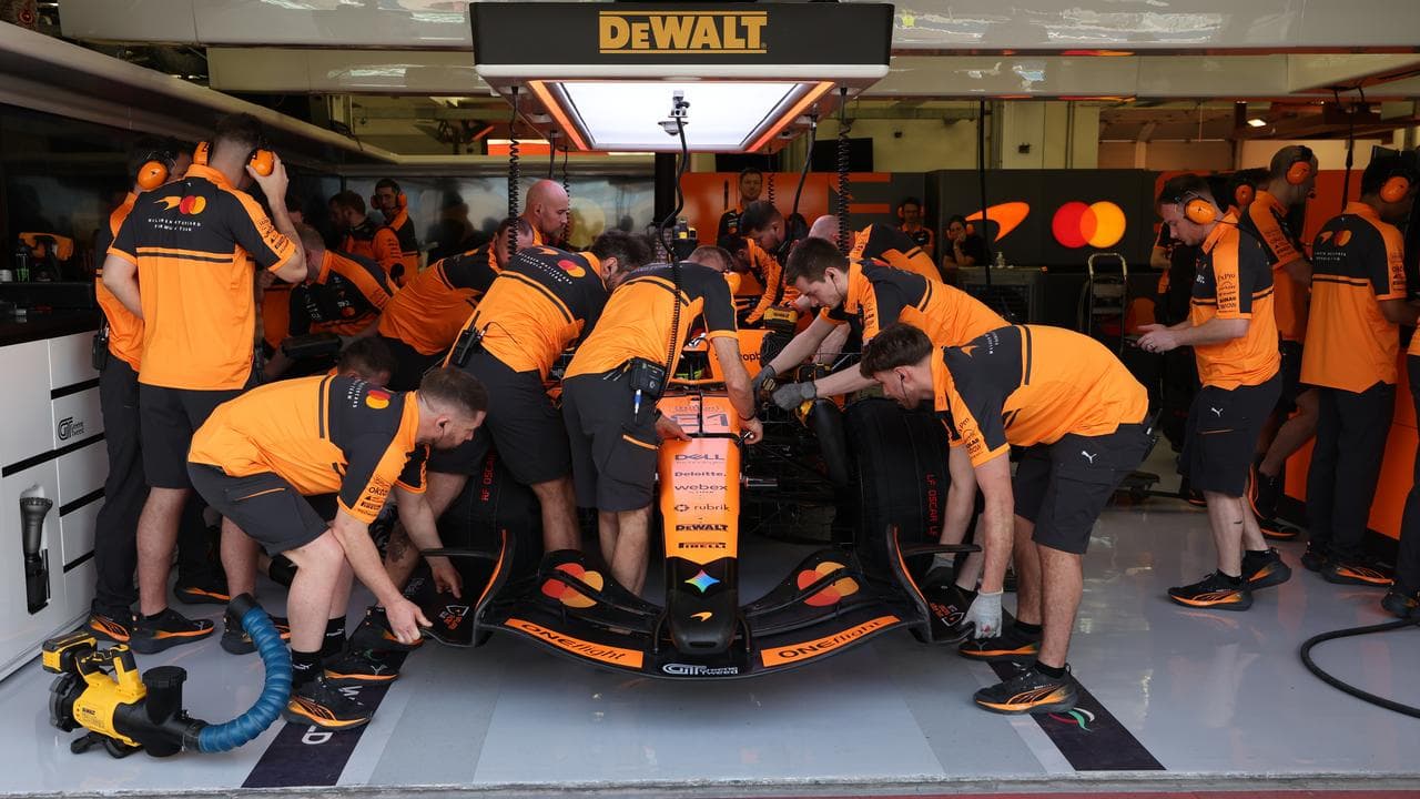 Mechanics work on the McLaren driver Oscar Piastri