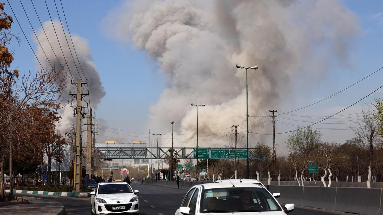 Smoke rises after an air strike in central Tehran