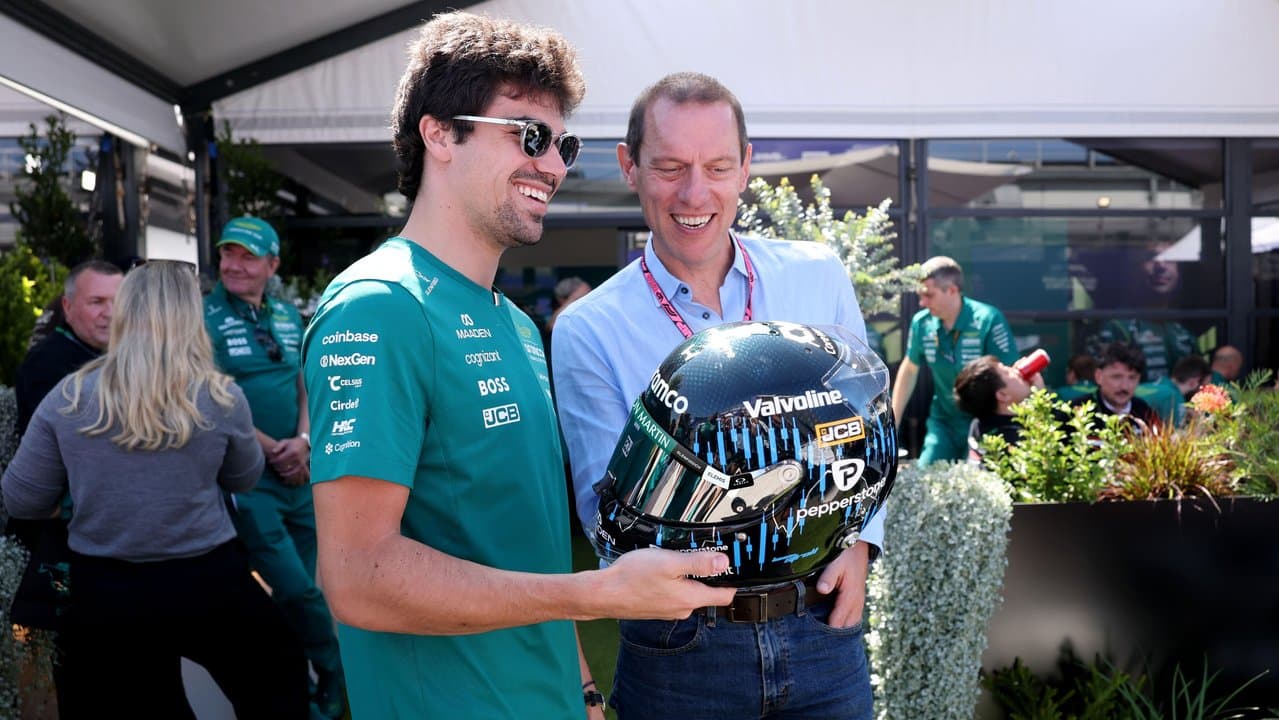 F1 driver Lance Stroll signs a racing helmet