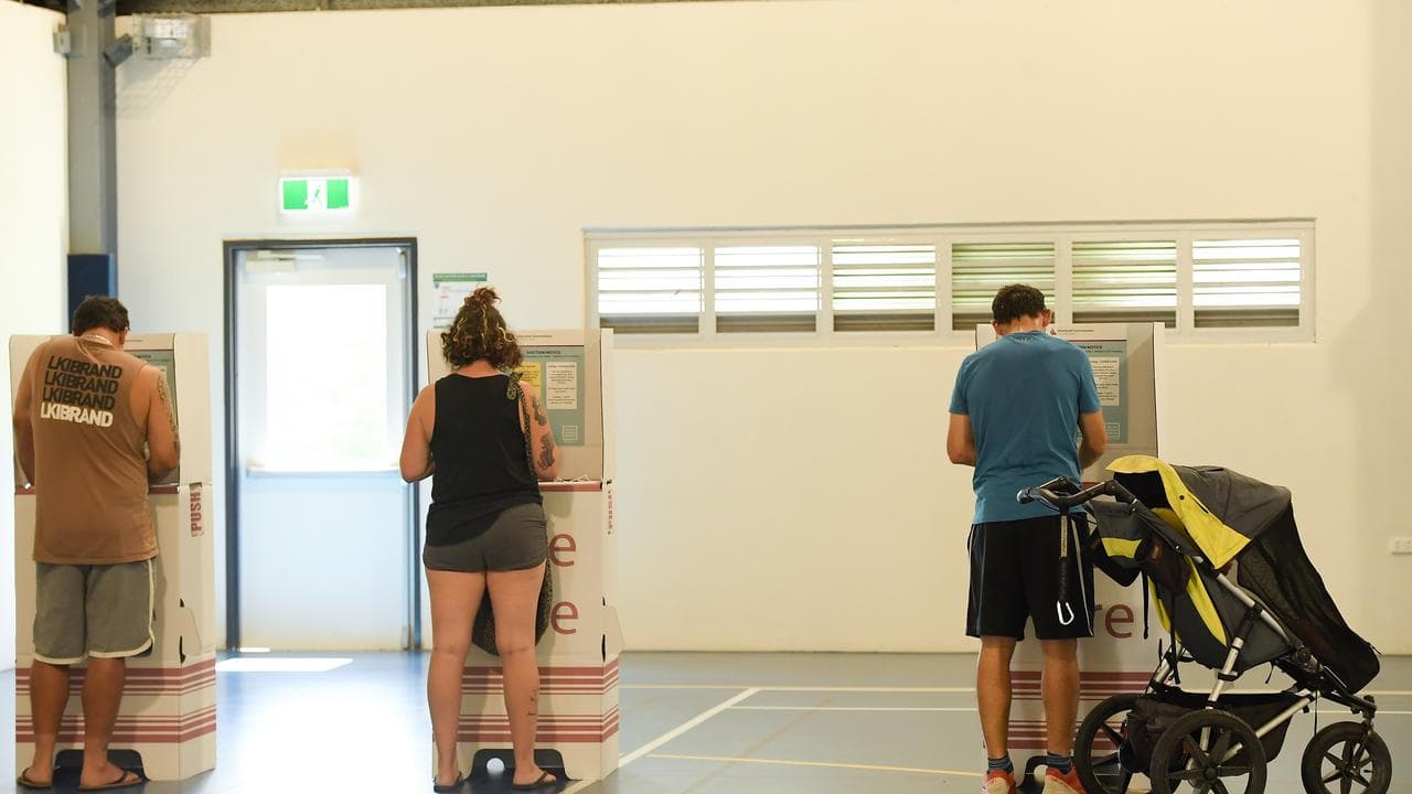 Three people at ballot boxes in Qld