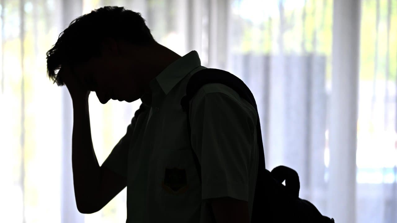 A silhouette of a male high school student t