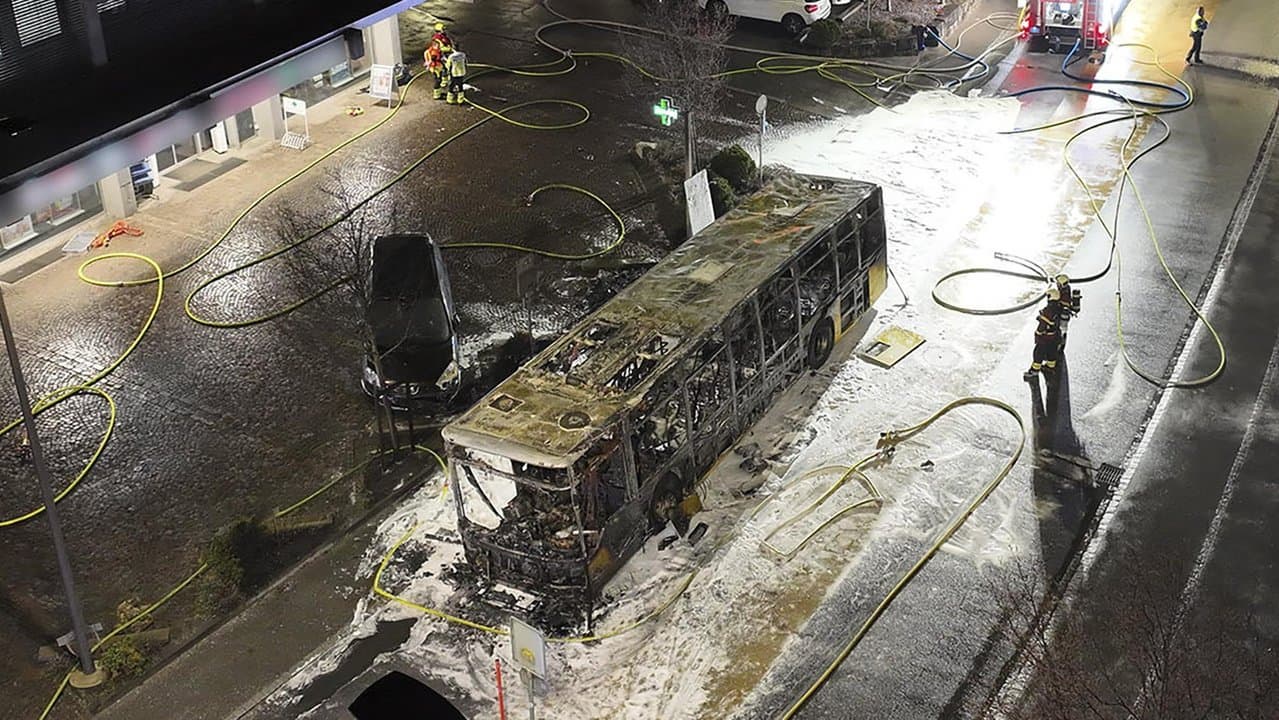 Shell of a postal bus after it caught fire in Kerzers, Switzerland,