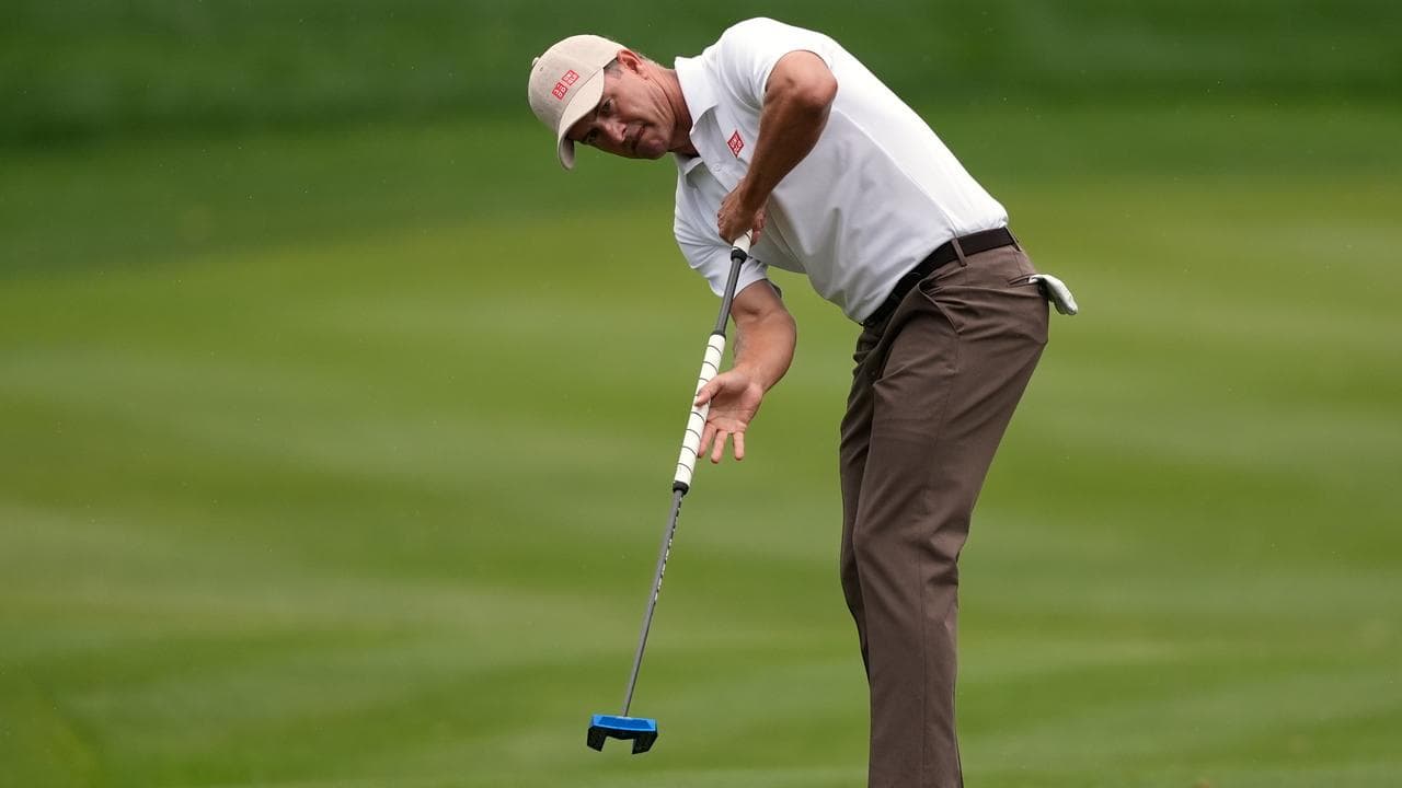 Adam Scott keeps a close eye on his putt.