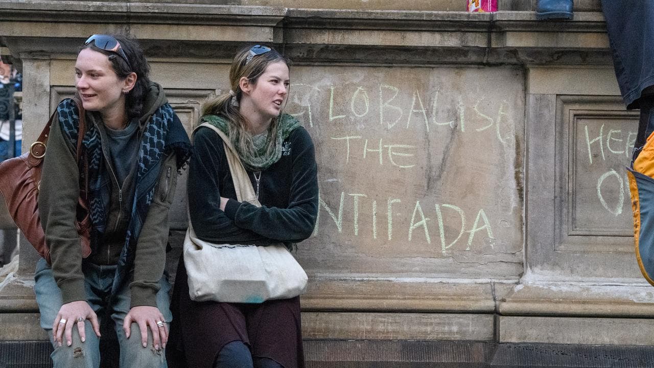 Protesters next to the words